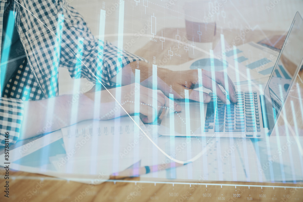 Obraz premium Multi exposure of stock market chart with man working on computer on background. Concept of financial analysis.
