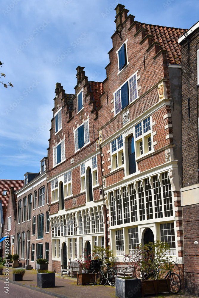 Naklejka premium Hoorn, the Netherlands - May 2020. Old leaning facades on the Veermanskade of the historic town of Hoorn in North Holland.
