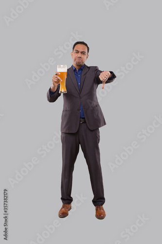 Businessman Holding Beer Glass Showing Thumb Down. Indian Business man Standing Full Length with Beer in Hand
