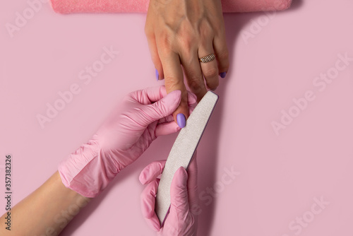 Manicure process on pink background, top view.Manicure in beauty salon.Manicure concept,