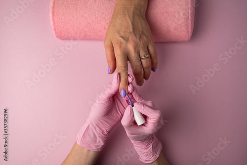 Manicure process on pink background, top view.Manicure in beauty salon.Manicure concept,