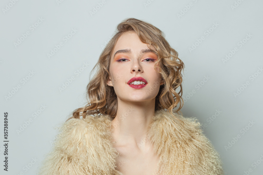 Portrait of nice woman in eco friendly faux fur coat on white background Portrait of nice woman in eco friendly faux fur coat on white background