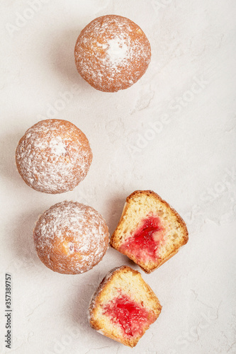 Mini Muffins with cherry jam on a textured background. View from above