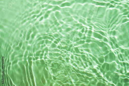 Green splashing cosmetic moisturizer  micellar water  toner  or emulsion background