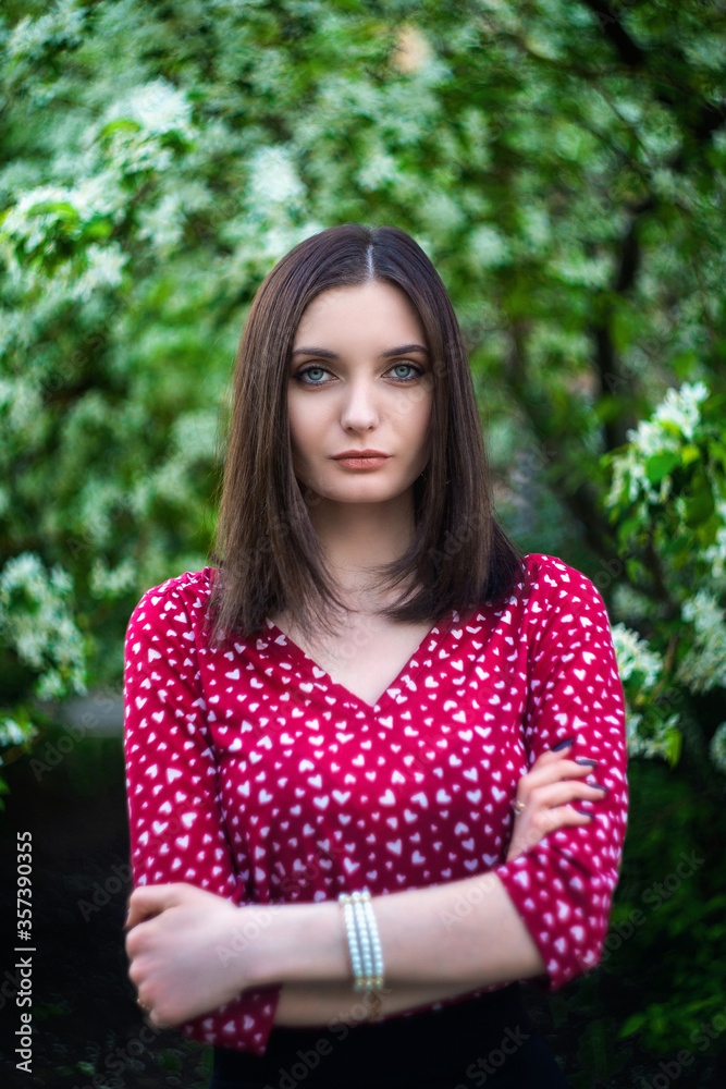 young, beautiful girl posing in blooming Apple orchards young, beautiful girl posing in blooming Apple orchards