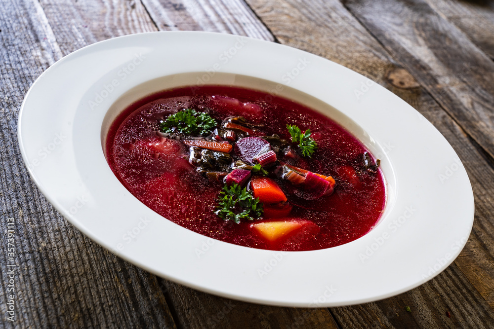 Borsch - beetroots soup on wooden table Borsch - beetroots soup on wooden table