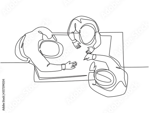 One continuous line drawing of young architect and construction builder discussing blueprint building design from top view. Home architecture concept. Single line draw design vector illustration