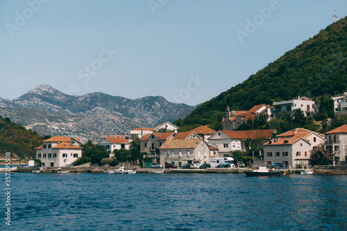 The coastline of the city of Lepetane in Montenegro, near the ferry crossing through Kotor Bay. © Nadtochiy