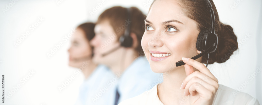 Call center. Diverse customer service operators in headsets at work in office. Business concept Call center. Diverse customer service operators in headsets at work in office. Business concept