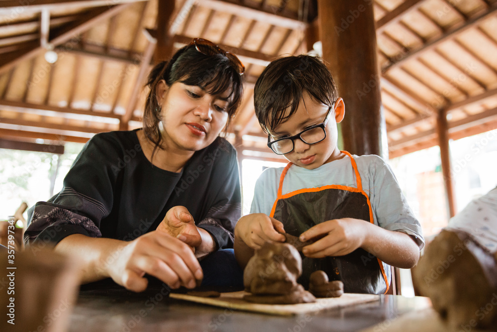 mother and her son try to make clay handicrafts in the pottery workshop gallery mother and her son try to make clay handicrafts in the pottery workshop gallery