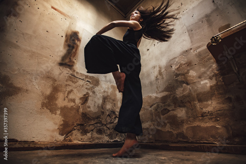 contemporary woman dancer rotates with flying hair