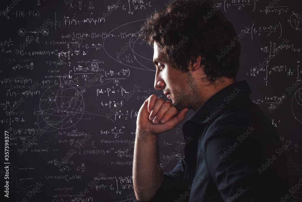 Human intellect. Training and research, concept. Pensive man and physical and mathematical formulas Human intellect. Training and research, concept. Pensive man and physical and mathematical formulas