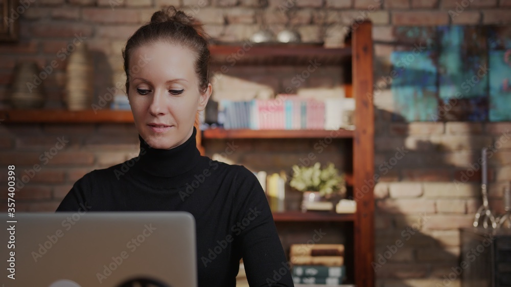 Adult woman in 30s working on laptop in home office, working from home online, using internet, thinking. Adult woman in 30s working on laptop in home office, working from home online, using internet, thinking.