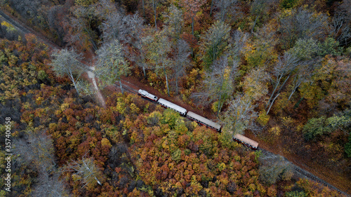 Children's train operate by children in Budapest. Forest train in amazing autumn colors. Bright lights, fantastic mood. The hills of Hungary.