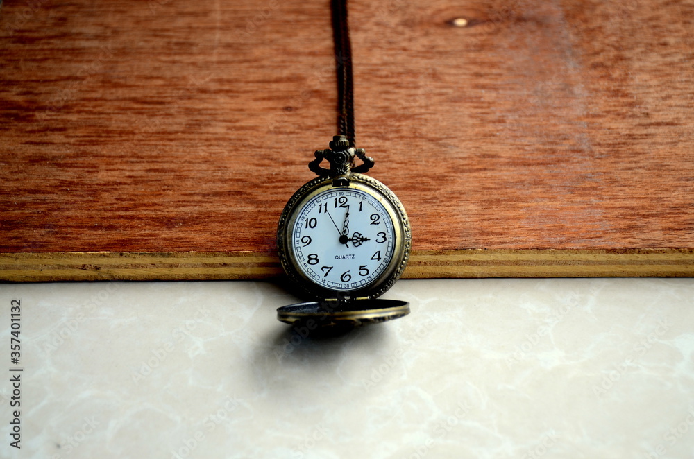 Dhaka, Bangladesh - April 25, 2020: A fashionable pocket watch with a golden chain in black background. Happy home photography during the quarantine. Stay home, stay safe. Dhaka, Bangladesh - April 25, 2020: A fashionable pocket watch with a golden chain in black background. Happy home photography during the quarantine. Stay home, stay safe.
