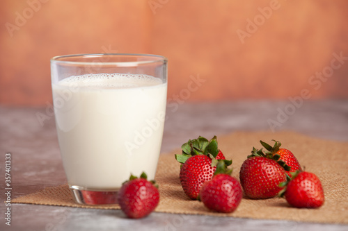 Strawberries arranged in pairs of bright white milk cups
