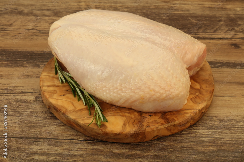 Raw whole chicken breast with skin Raw whole chicken breast with skin