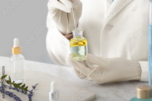 Beautician preparing natural cosmetic in laboratory, closeup