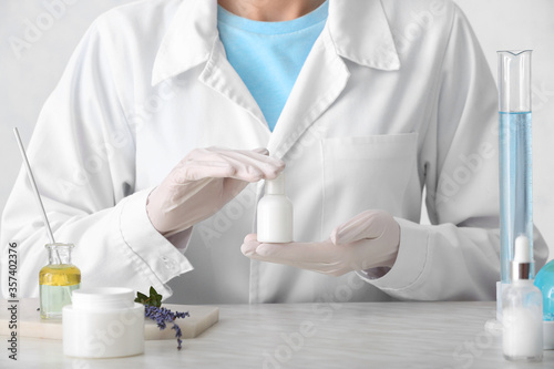 Beautician preparing natural cosmetic in laboratory, closeup