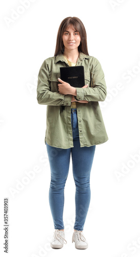 Young woman with Bible on w...