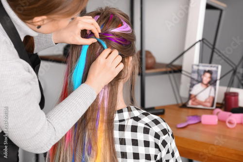 Hairdresser working with yo...