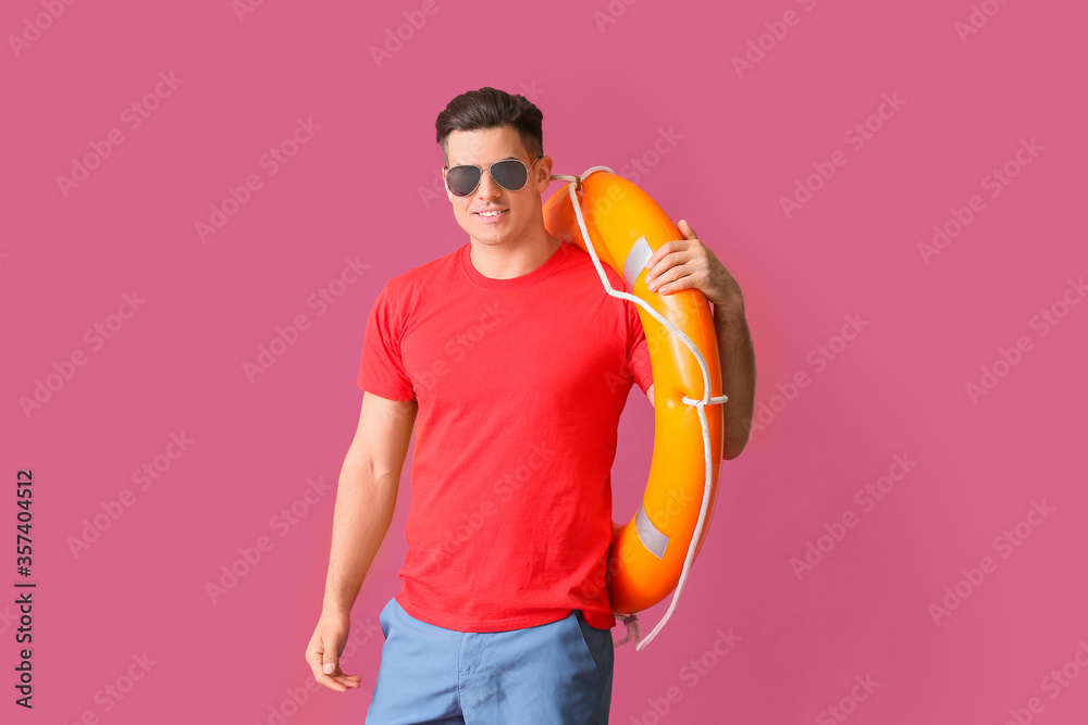 Beach rescuer with lifebuoy on color background Beach rescuer with lifebuoy on color background