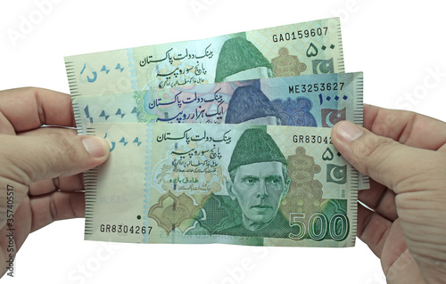 Pakistani currency note hold in hand