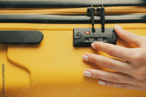 Bild auf Leinwand Woman opening lock on suitcase, closeup