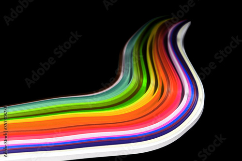Abstract color wave curl rainbow strip paper on black background
