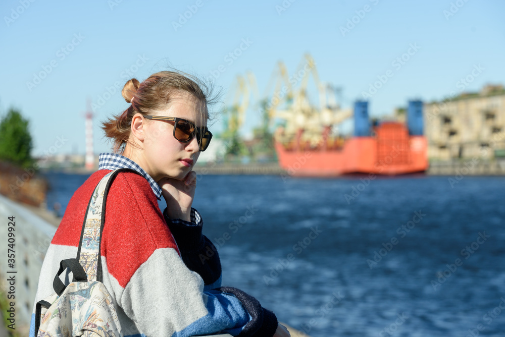 A girl alone in a commercial seaport on a walk A girl alone in a commercial seaport on a walk
