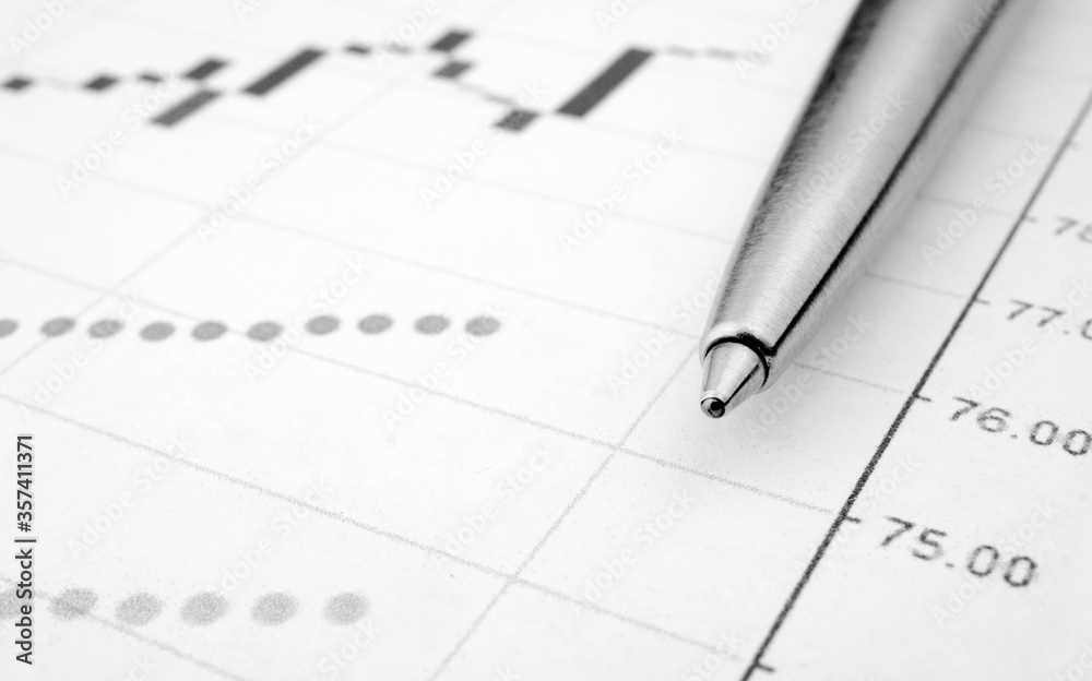 Trading chart and pen on a sheet of paper. Stock quotes in the form of a graph. Business project on paper. Profitable shares. Profit from financial activities. Risky business.