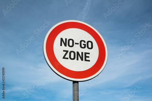 No-go zone - warning traffic sign and roadsign is marking forbidden and prohibited area in city, town and neighborhood. No trespassing and entry to the area and territory.