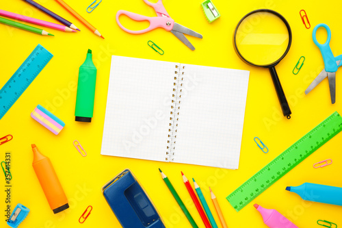 Back to school concept on yellow background. Top view