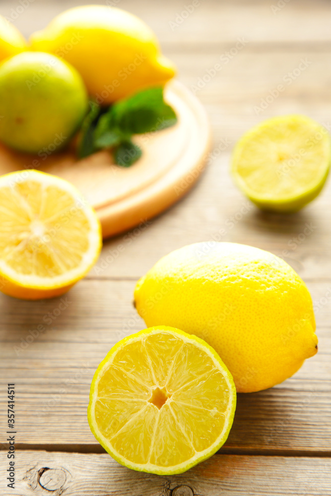 Fresh ripe citruses with mint on grey wood table. Vertical Fresh ripe citruses with mint on grey wood table. Vertical