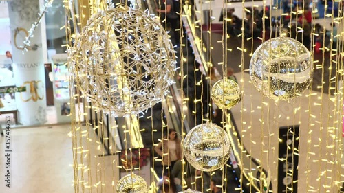 Christmas decorations in Magnolia Park Shopping Mall. People on escalator, in festive decorated business center, make New Year's purchases,.