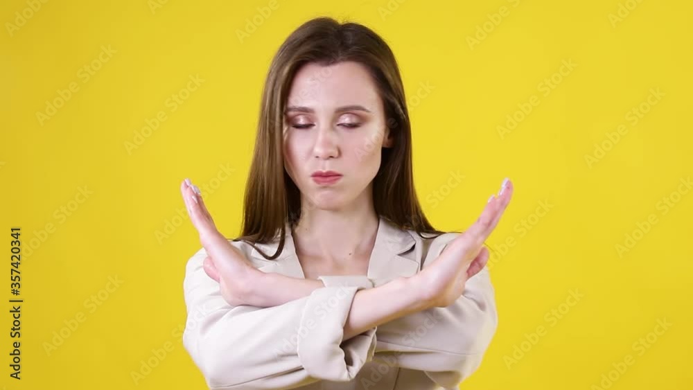 Stop Gesture by business lady on yellow background. Businesswoman showing stop gesture sign with hands. No, never Stop Gesture by business lady on yellow background. Businesswoman showing stop gesture sign with hands. No, never