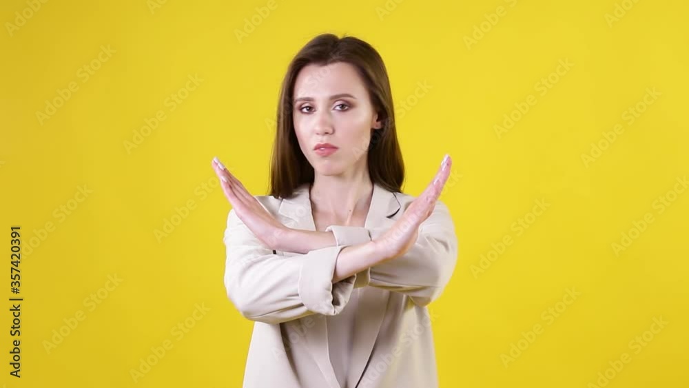 Stop Gesture by business lady on yellow background. Businesswoman showing stop gesture sign with hands. No, never Stop Gesture by business lady on yellow background. Businesswoman showing stop gesture sign with hands. No, never