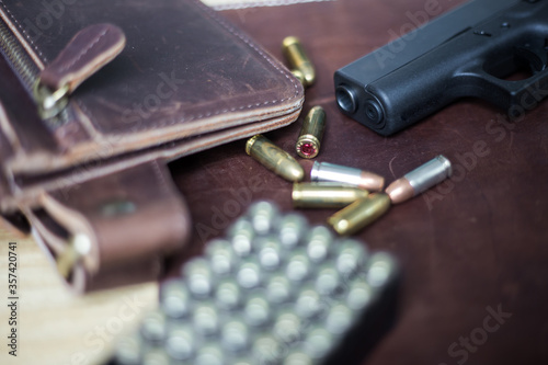 9mm conceal polymer gun with fmj bullet in leather gun photo