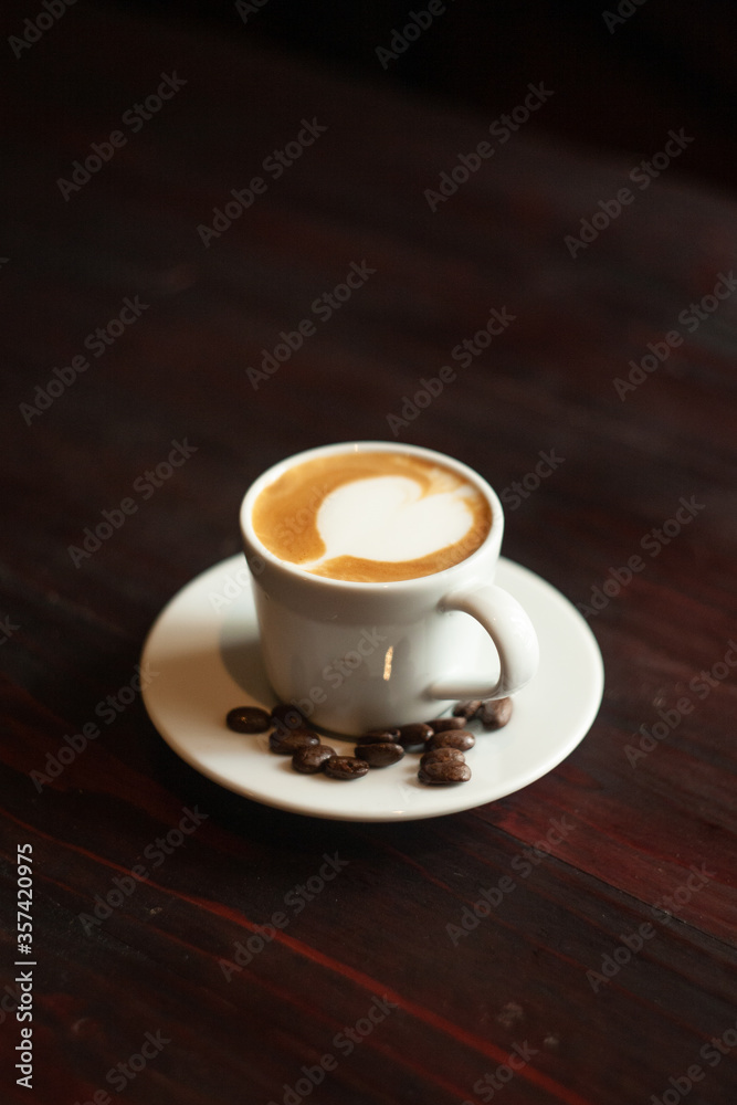 Coffee cup and coffee beans on wooden table. Coffee cup and coffee beans on wooden table.