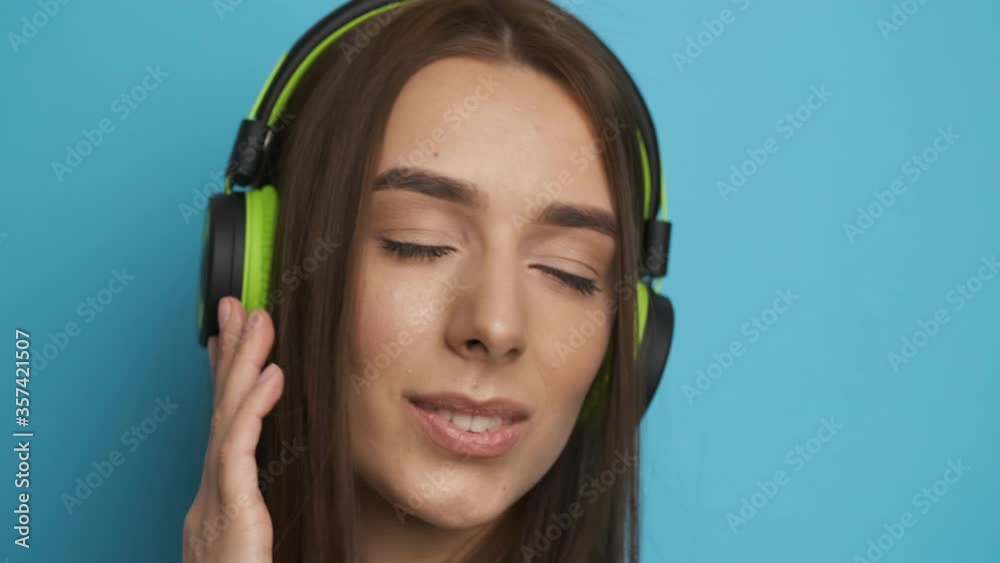 Woman after a hard day's work relaxes and listens to music in green headphones