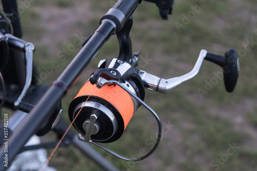 Fishing rods closeup. Carp reels on a stand in a pond