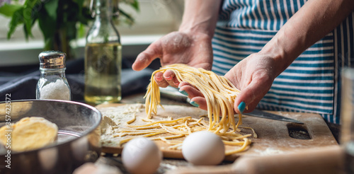 Εκτύπωση καμβά Woman is carefully holding raw homemade noodles in her hands