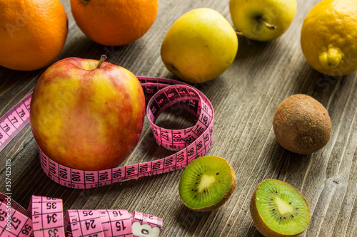 fruits and measuring tape that means healthy lifestyle