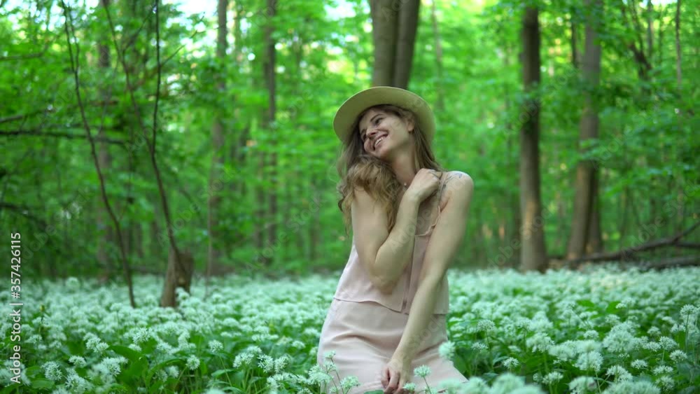 Beautiful woman walking in a forest meadow Beautiful woman walking in a forest meadow
