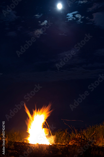 campfire night on the background of the moon