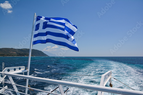 Greek flag on board a cruise boat travelling along Mount Athos Monasteries from Ouranoupolis port, Halkidiki, Greece