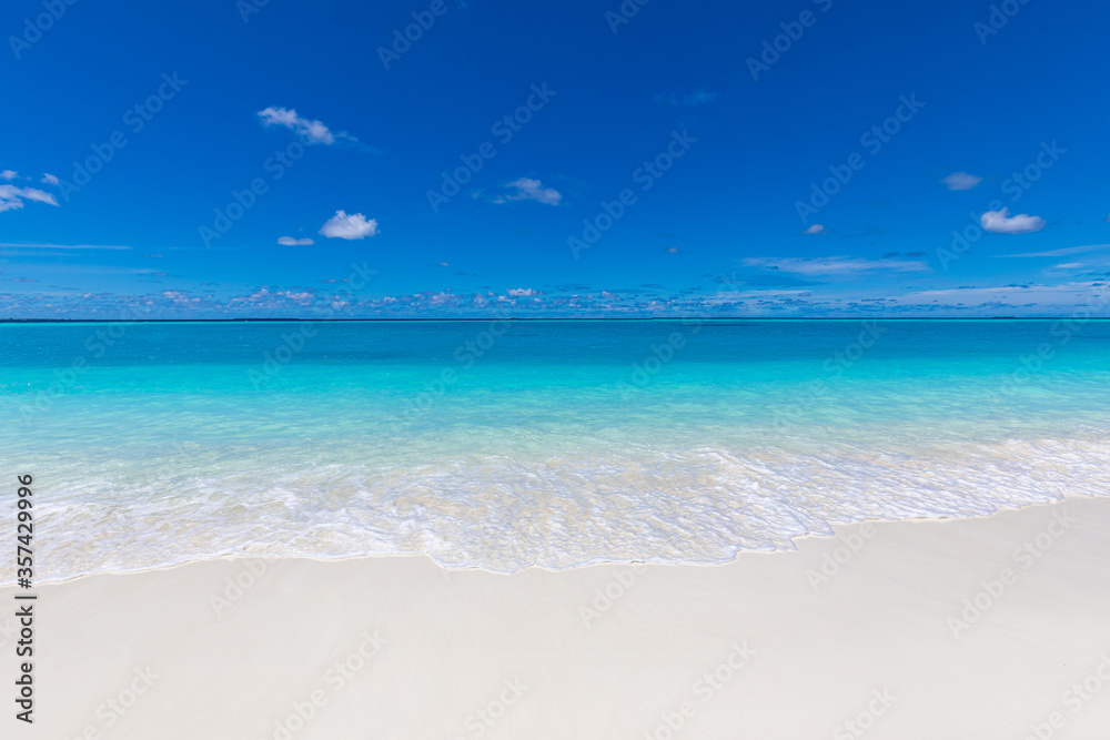 Sea sand sky. Calm relaxing waves on tropical beach. Summer vibes, sea horizon with shades of blue. Empty beach scenery, summer vacation and holiday template. Exotic travel