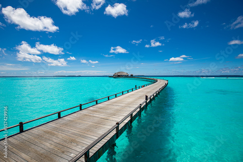 Tropical landscape of Maldives beach. Seascape panorama  luxury water villa resort with wooden pier or jetty. Luxury travel destination background for summer holiday and vacation concept.