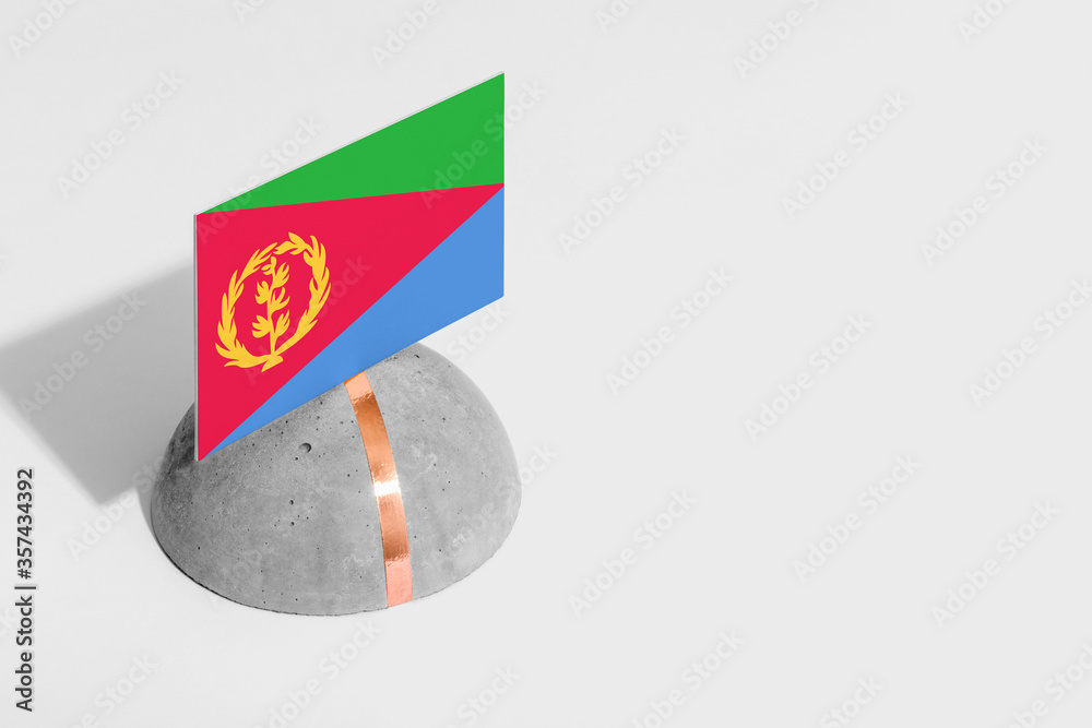 Naklejka premium Eritrea flag tagged on rounded stone. White isolated background. Side view minimal national concept.