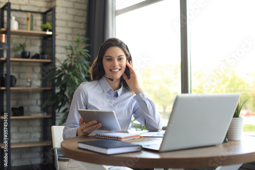 Freelance business women using tablet working call video conference with customer in workplace at home.